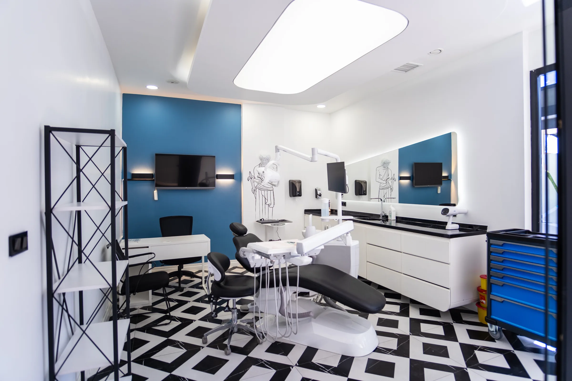 Behandelkamer met blauwe accentwand en zwart-witte vloer